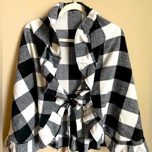 Beautiful buffalo plaid wrap with ruffles and ties in front. Boutique purchased.